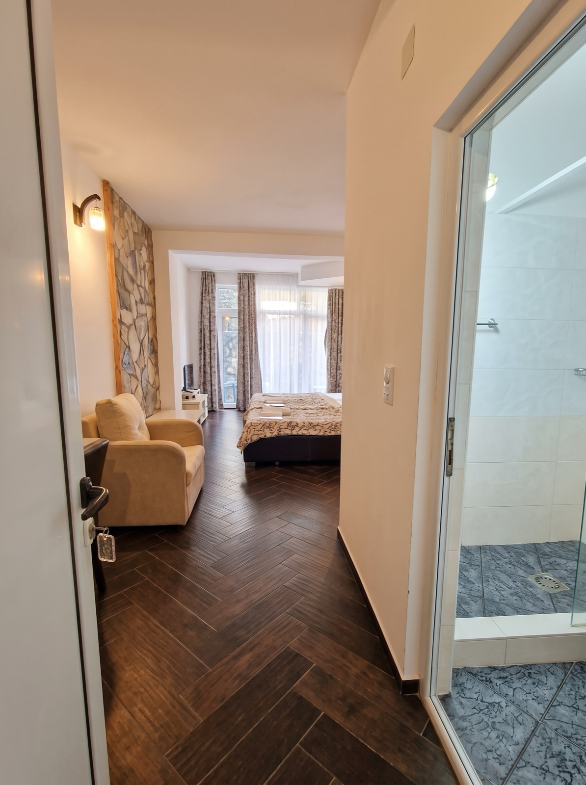 Classic Apartment at Azura Bay — living area, kitchenette and sea-view balcony